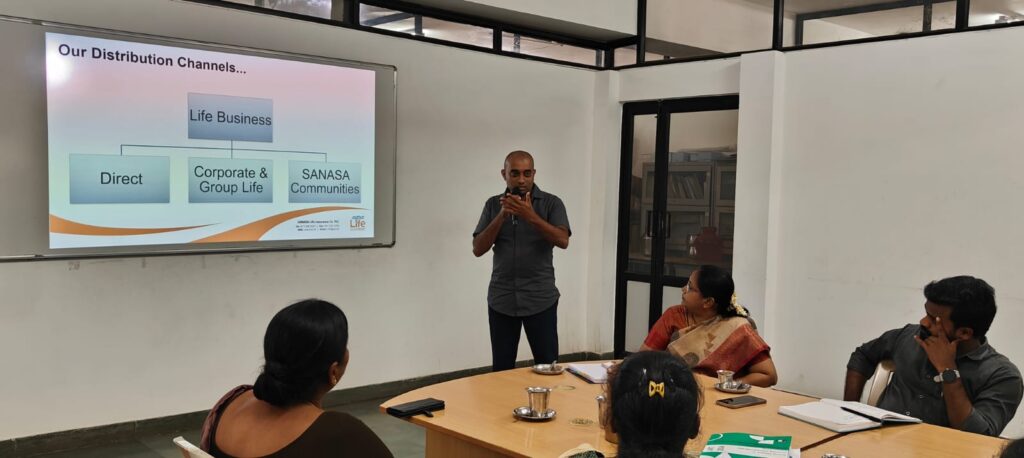 Photo: P.G. Asanka Gayan (standing) speaking about SANASA Life during the DHAN Foundation ART training course, September 2024.